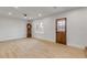 Open living space featuring hardwood floors, white walls, and a rustic wooden door at 118 E Palm Way, Edgewater, FL 32132