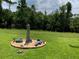 Landscaped backyard featuring a decorative lighthouse and alligator statues surrounded by lush green grass at 123 Old Mill Pond Rd, Edgewater, FL 32141