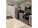 This modern kitchen features grey cabinets, stainless steel appliances, pantry and light countertops at 123 Old Mill Pond Rd, Edgewater, FL 32141