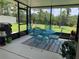 Relaxing screened-in patio with a turquoise patio set and a view of the backyard at 123 Old Mill Pond Rd, Edgewater, FL 32141