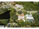 Aerial view showcasing the home's location near a pond and lush greenery at 1240 Wayne Ave, New Smyrna Beach, FL 32168