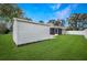 Spacious backyard featuring a shed, screened-in porch, and a white privacy fence at 1240 Wayne Ave, New Smyrna Beach, FL 32168