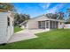 Backyard featuring a shed, concrete walkway, and screened-in porch at 1240 Wayne Ave, New Smyrna Beach, FL 32168