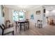 Cozy dining room features a window view and hardwood flooring at 1240 Wayne Ave, New Smyrna Beach, FL 32168