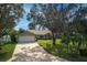 Attractive single-Gathering home featuring a spacious driveway, two-car garage and mature landscaping at 1240 Wayne Ave, New Smyrna Beach, FL 32168