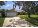 Inviting home with a wide driveway, two-car garage, and lush green lawn at 1240 Wayne Ave, New Smyrna Beach, FL 32168