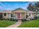 Charming home with a welcoming front porch, well-maintained lawn and landscaped garden at 1240 Wayne Ave, New Smyrna Beach, FL 32168