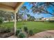 Landscaped front yard with lake views and mature landscaping at 1240 Wayne Ave, New Smyrna Beach, FL 32168