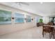 Bright living room with tile floors, multiple windows, and ceiling fan at 1240 Wayne Ave, New Smyrna Beach, FL 32168