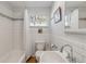 Bright bathroom featuring tiled walls, a bathtub with shower, and a window for natural light at 128 Dixwood Ave, Edgewater, FL 32132