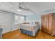 Comfortable bedroom featuring hardwood floors, a ceiling fan, and natural light at 128 Dixwood Ave, Edgewater, FL 32132