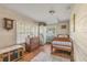 Comfortable bedroom featuring wood paneling, hardwood floors, and natural light at 128 Dixwood Ave, Edgewater, FL 32132