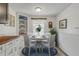 Charming dining area with a round table, blue rug, and decorative shelving at 128 Dixwood Ave, Edgewater, FL 32132