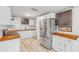 Modern kitchen with butcher block countertops, stainless steel appliances, and ample cabinet space at 128 Dixwood Ave, Edgewater, FL 32132