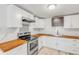 Well-lit kitchen featuring butcher block countertops, stainless steel appliances, and modern cabinetry at 128 Dixwood Ave, Edgewater, FL 32132