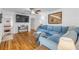 Spacious living room with hardwood floors, blue sofa, and an open view to the hallway at 128 Dixwood Ave, Edgewater, FL 32132