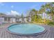 Outdoor pool surrounded by wooden deck, landscaping, and a blue house at 128 Dixwood Ave, Edgewater, FL 32132