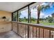 Private balcony offering a tranquil view of the lush greenery and swaying palm trees at 144 S Halifax Ave # 26, Daytona Beach, FL 32118