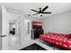 Bedroom featuring a ceiling fan, adjacent doorways, and minimalist decor at 144 S Halifax Ave # 26, Daytona Beach, FL 32118