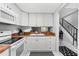 Cozy kitchen featuring white cabinets and a unique granite countertop, located near the staircase at 144 S Halifax Ave # 26, Daytona Beach, FL 32118