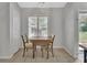 Dining area featuring neutral walls, tile floors, plantation shutters and view to the outside at 1462 General Mcarthur Ave, Daytona Beach, FL 32124