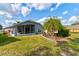 Well-manicured backyard showcasing lush landscaping and a covered patio, perfect for outdoor enjoyment at 1502 Areca Palm Dr, Port Orange, FL 32128