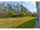 Expansive backyard with lush lawn and mature landscaping providing privacy at 1502 Areca Palm Dr, Port Orange, FL 32128