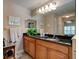 The bathroom features wood cabinets, black granite countertops, and double sinks at 1502 Areca Palm Dr, Port Orange, FL 32128