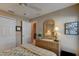 Cozy bedroom featuring a ceiling fan, closet, and a wicker dresser with decorative lamp for a relaxing retreat at 1502 Areca Palm Dr, Port Orange, FL 32128