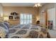 This bedroom features neutral paint, a ceiling fan and natural light from the plantation shutters at 1502 Areca Palm Dr, Port Orange, FL 32128