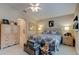 This bedroom features neutral paint, a ceiling fan and a wrought iron bed frame at 1502 Areca Palm Dr, Port Orange, FL 32128