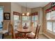 Charming breakfast nook with a round table, decorative window valances, and natural light for a cozy dining space at 1502 Areca Palm Dr, Port Orange, FL 32128