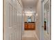 Hallway view leading to the bathroom vanity and mirror at 1502 Areca Palm Dr, Port Orange, FL 32128