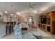 Bright and airy living room featuring neutral tones, a ceiling fan, and a stylish entertainment center at 1502 Areca Palm Dr, Port Orange, FL 32128