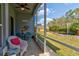 Relaxing screened patio offers a tranquil view of the well-maintained backyard and lush landscaping at 1502 Areca Palm Dr, Port Orange, FL 32128