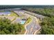 Aerial view of a neighborhood with a community pool, homes, and green space at 1731 Red Rock Rd, New Smyrna Beach, FL 32168