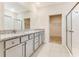 Bathroom with double vanity, granite countertops, tiled floor, and glass shower door at 1731 Red Rock Rd, New Smyrna Beach, FL 32168