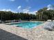 Inviting community pool with chairs for lounging and surrounding greenery at 1731 Red Rock Rd, New Smyrna Beach, FL 32168