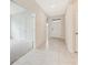 Bright hallway with neutral paint and tile floors leads to the front door and other rooms at 1731 Red Rock Rd, New Smyrna Beach, FL 32168