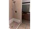 Tiled bathroom featuring a shower and vanity, needing updates at 1774 Concert Rd, Deltona, FL 32738