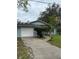 A home with a garage and yard, plus a walkway leading to the house at 1774 Concert Rd, Deltona, FL 32738