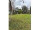 The home has a lush front yard, trees, and grass at 1774 Concert Rd, Deltona, FL 32738