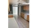 Well-lit kitchen featuring tiled floors, classic wood cabinetry, and modern white appliances at 1774 Concert Rd, Deltona, FL 32738