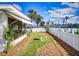 Landscaped backyard featuring a birdbath, privacy fence, and tropical plants in a well-maintained lawn at 18 Silk Oaks Dr, Ormond Beach, FL 32176