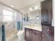 Bathroom featuring a shower, vanity, cabinet and commode at 18 Silk Oaks Dr, Ormond Beach, FL 32176