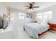 Bright bedroom with a large bed, fan, natural light, and stylish mid-century modern decor at 18 Silk Oaks Dr, Ormond Beach, FL 32176