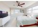 Bright bedroom with a large bed, fan, natural light, and stylish mid-century modern decor at 18 Silk Oaks Dr, Ormond Beach, FL 32176