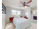 Bedroom featuring an ensuite bathroom, closet with mirrored doors, and a large light-filled window at 18 Silk Oaks Dr, Ormond Beach, FL 32176