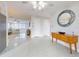 Open entryway with terrazzo floors, hall mirror, and natural wood storage cabinet at 18 Silk Oaks Dr, Ormond Beach, FL 32176