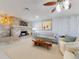 Cozy living room with stone fireplace, wood-paneled walls, stylish furniture and a ceiling fan at 18 Silk Oaks Dr, Ormond Beach, FL 32176